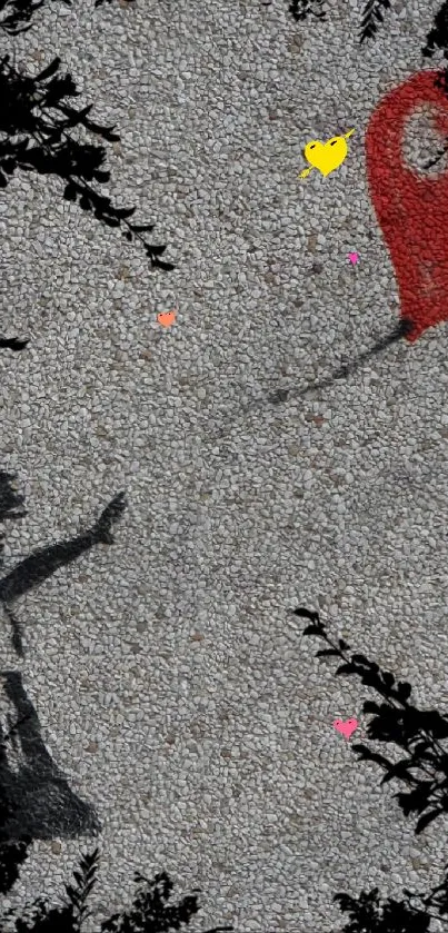 Graffiti of a girl releasing a red balloon against a textured gray wall.