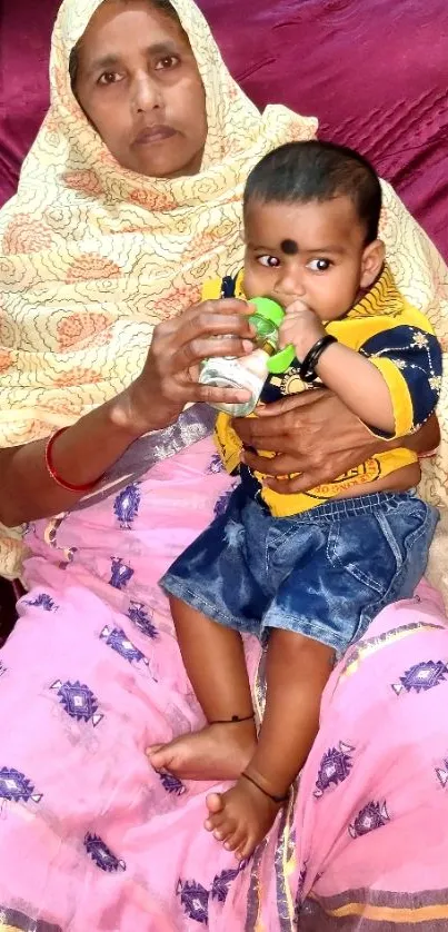 Grandmother holding her grandchild, both smiling warmly.