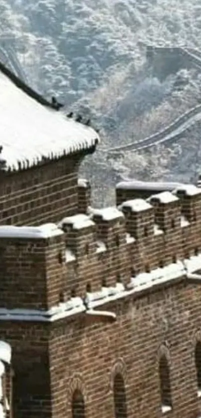 Snow-capped Great Wall of China with scenic mountain backdrop.