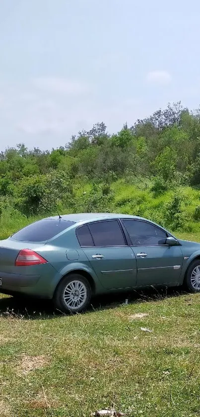 Green car parked in a lush nature setting, perfect for mobile wallpaper.