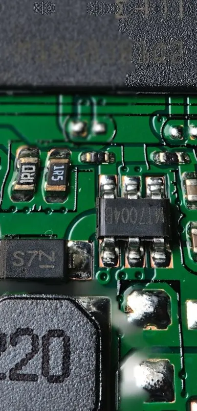 Detailed view of a green circuit board with various electronic components.