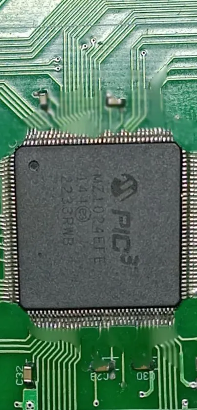 Close-up of a green circuit board with a central processor chip.