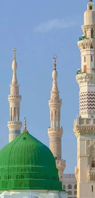 Wallpaper of mosque with Green Dome and minarets under blue sky.