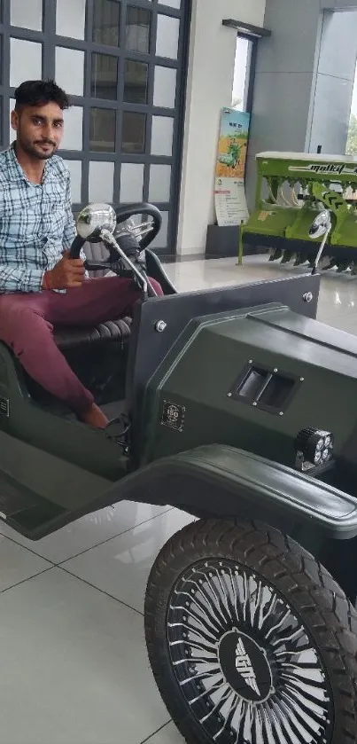 Green electric car in showroom with person seated.