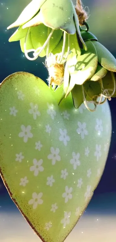 Green heart with floral pattern and leafy top against a serene background.