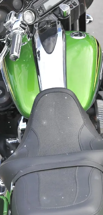 Close-up of a green motorcycle seat with chrome details.