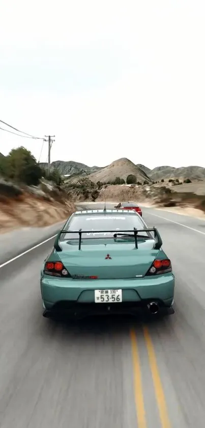 Car speeding on a scenic mountain road.