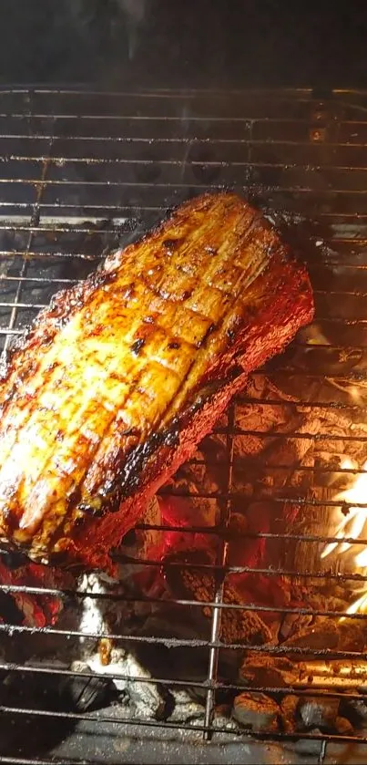 Grilled ribs sizzling over open flames on a barbecue grill.