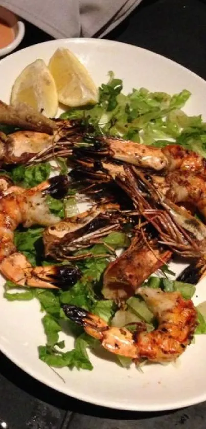 Grilled shrimp and salad with lemon on a plate.