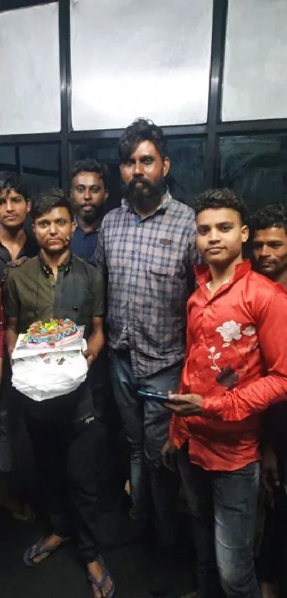 Group of people celebrating with cake indoors.