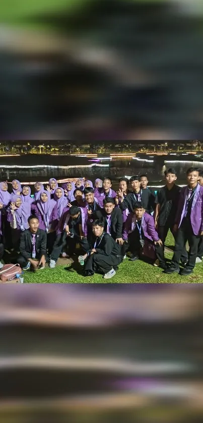 Group of people at a night event, wearing purple attire and smiling.