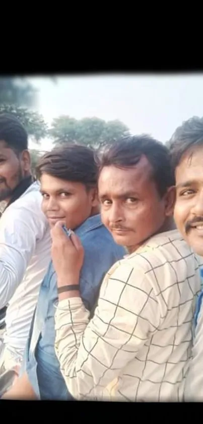 Four friends riding a motorbike together, outdoors