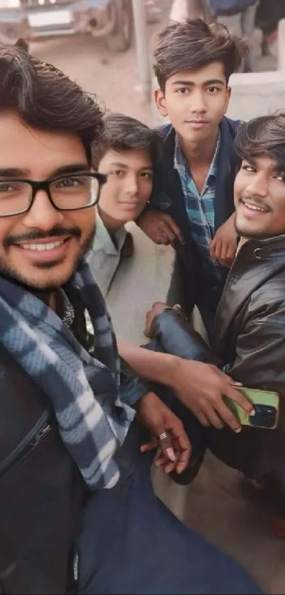 Group of young friends taking a selfie together outdoors.