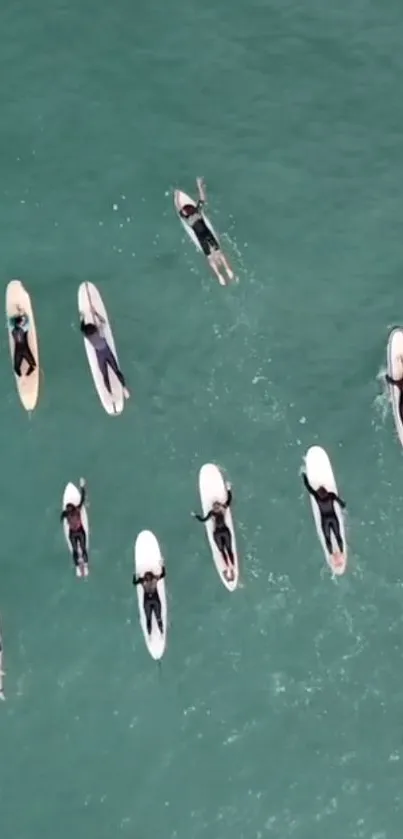 Aerial view of surfers on turquoise water.