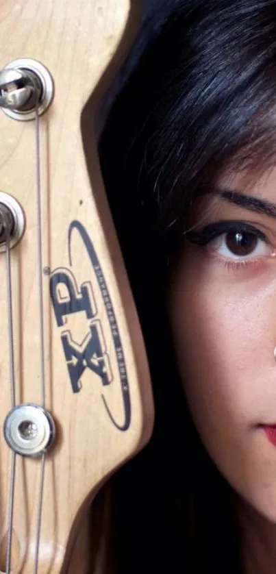 Guitar neck and woman's half face with bold makeup.