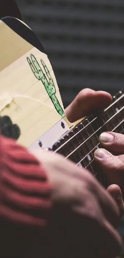 Close-up of a person playing an electric guitar with a dark background.