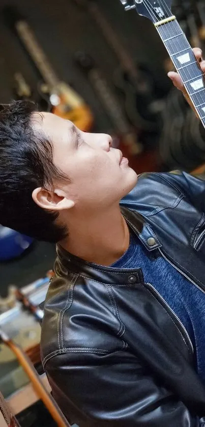 Person in a leather jacket admiring a guitar in a music store.