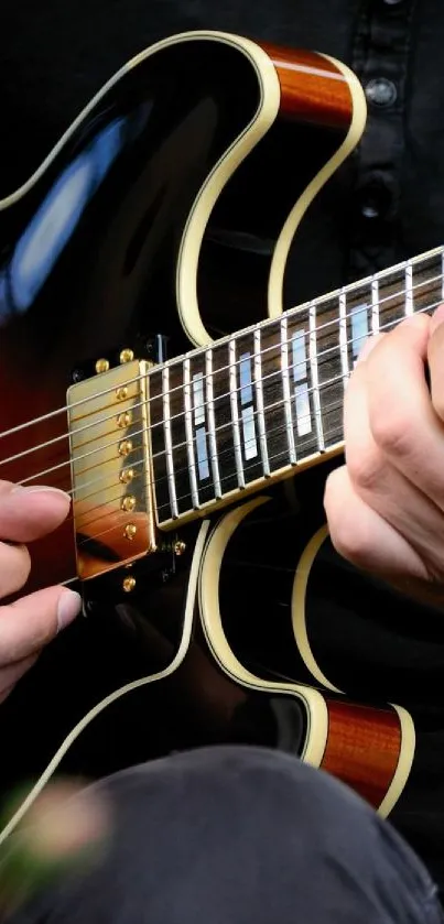 Close-up of hands playing a guitar, highlighting the fretboard and strings.