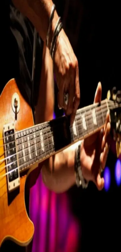 Close-up of guitarist playing electric guitar on stage.