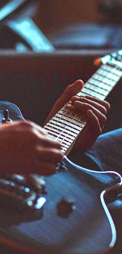 Hands strumming an acoustic guitar in a close-up view.