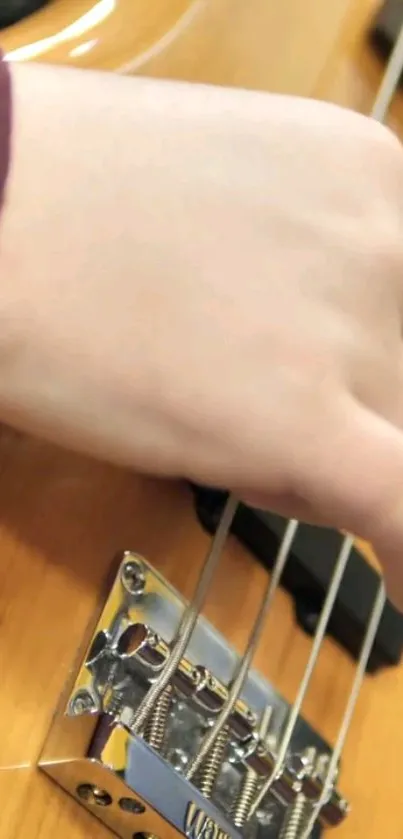 Close-up of fingers on guitar strings with light brown tones.