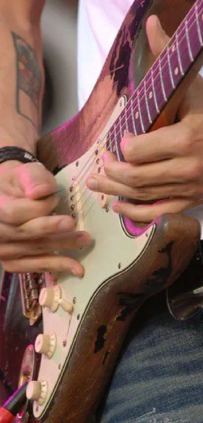 Close-up of hands playing an electric guitar, capturing live music action.