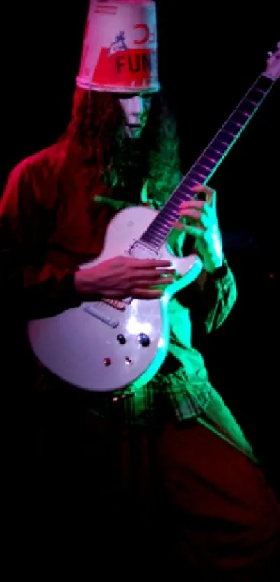 Guitarist playing on stage with colorful lighting.