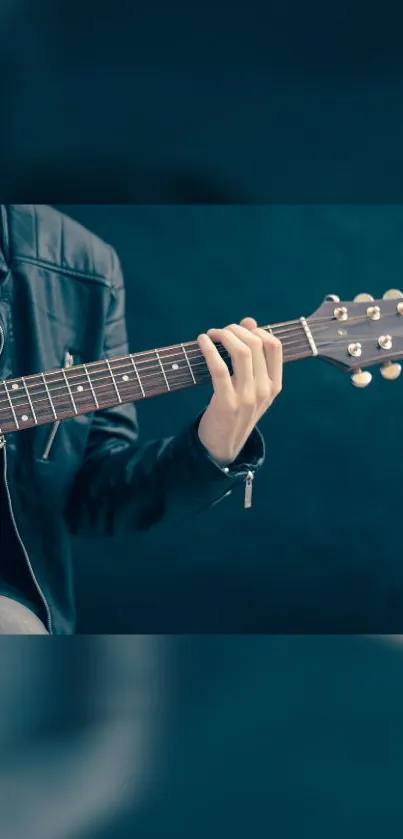 Guitarist in a leather jacket playing an acoustic guitar with a midnight blue background.