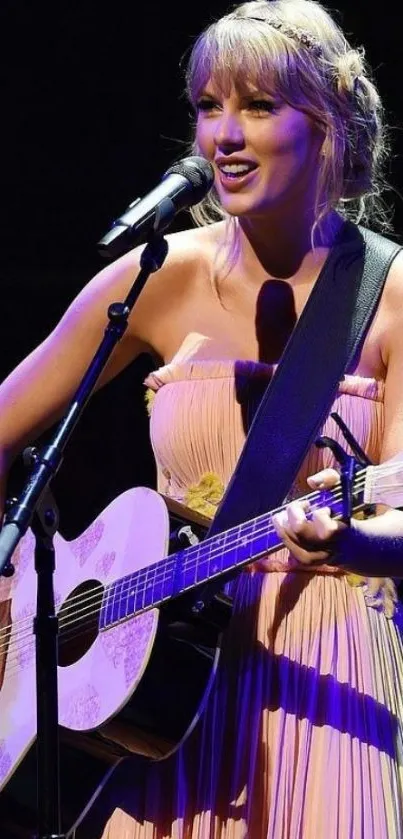 A musician plays guitar on stage with vibrant lighting.