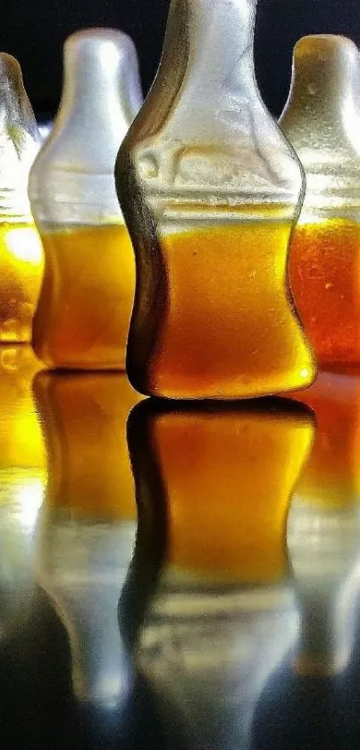 Gummy cola bottles with amber hues and reflections.