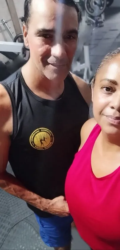 Couple taking a selfie at the gym, showcasing fitness and motivation.