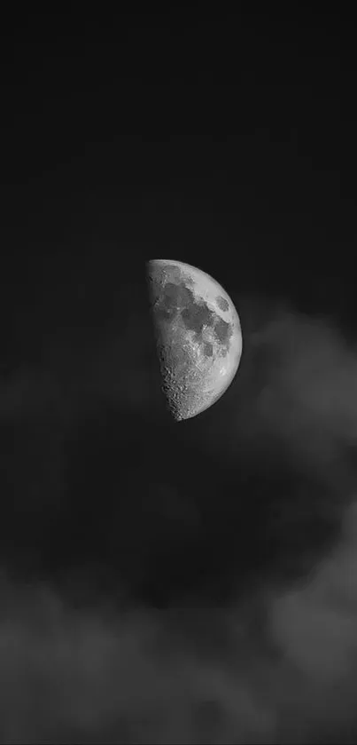 Half moon in a cloudy night sky, black and white mobile wallpaper.