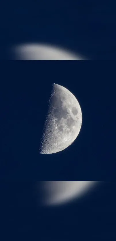 Half moon under a dark blue night sky.