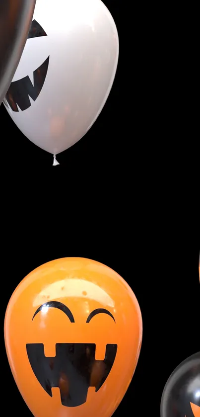 Halloween-themed balloons with jack-o'-lantern faces on a black background.