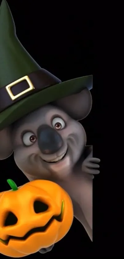 Koala in witch hat holding a glowing pumpkin.