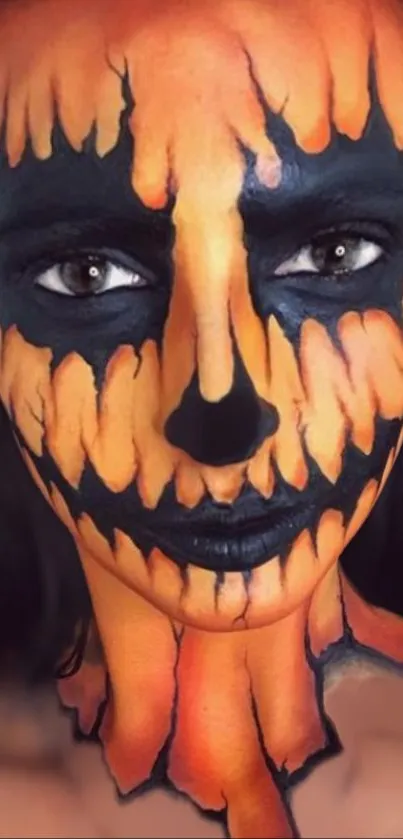 Pumpkin face paint with black and orange tones for Halloween.