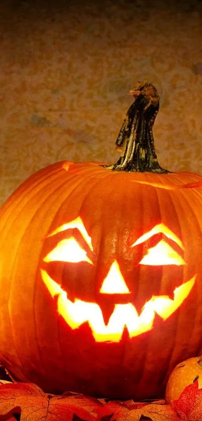 Three glowing carved Halloween pumpkins with autumn leaves.