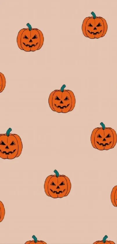 Smiling pumpkins decorate a peach wallpaper.