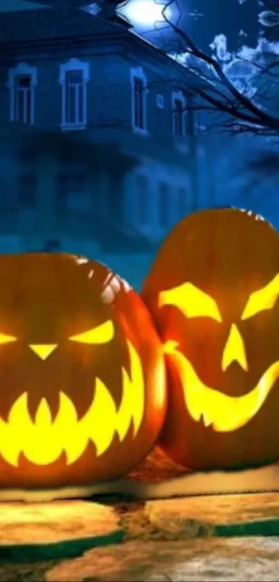 Halloween pumpkins glowing at night with a spooky house in the background.