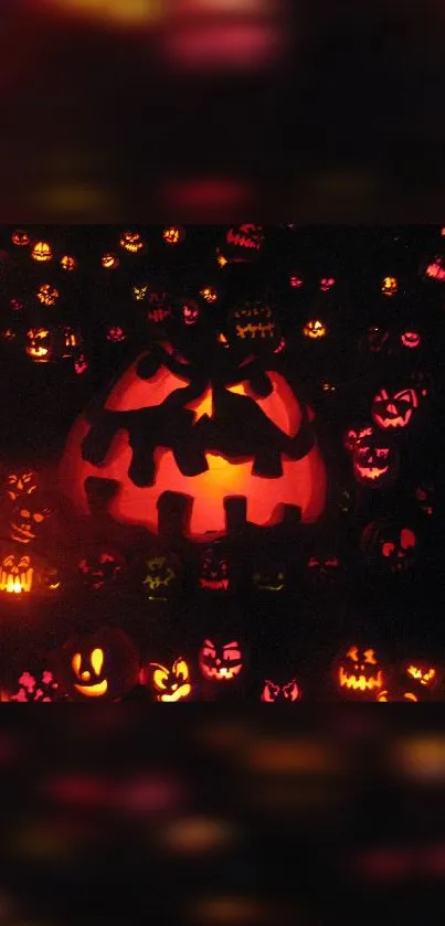 Spooky Halloween pumpkin wallpaper with glowing jack-o'-lantern faces.