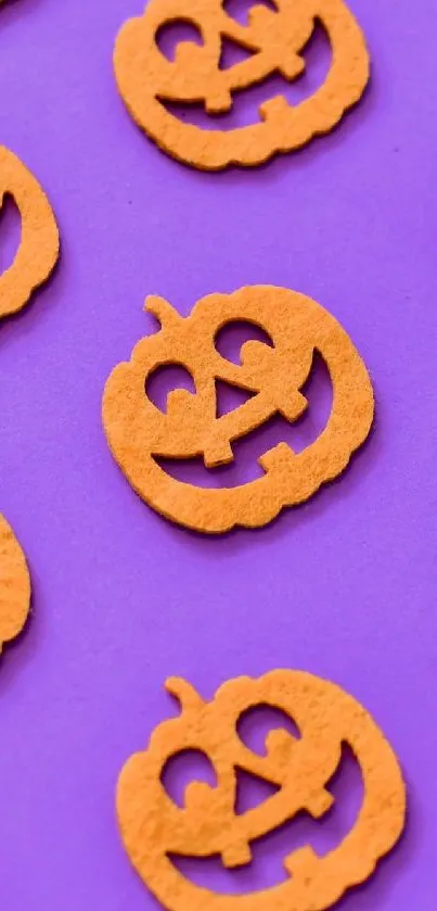 Orange pumpkin pattern on vibrant purple background for mobile wallpaper.