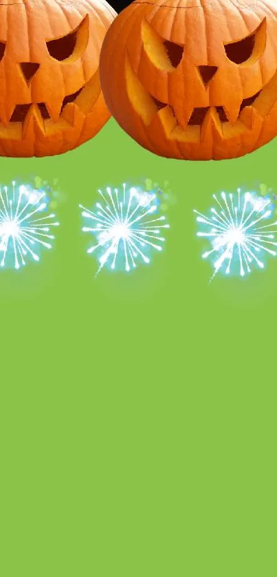 Halloween pumpkins and fireworks on green background.