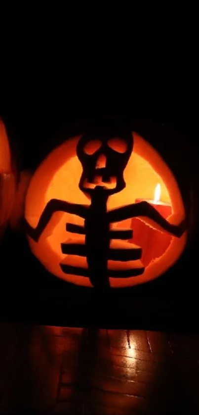 Glowing skeleton carving on Halloween pumpkin in the dark.