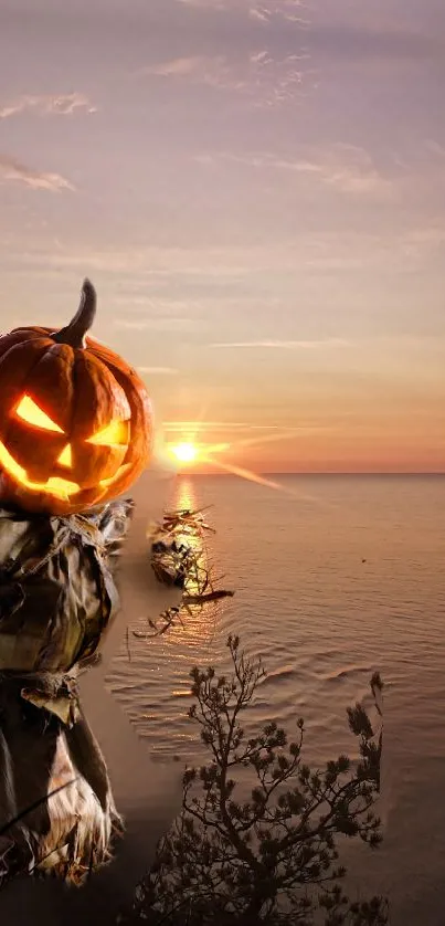 Halloween themed wallpaper with a glowing pumpkin beside a sunset on the sea.