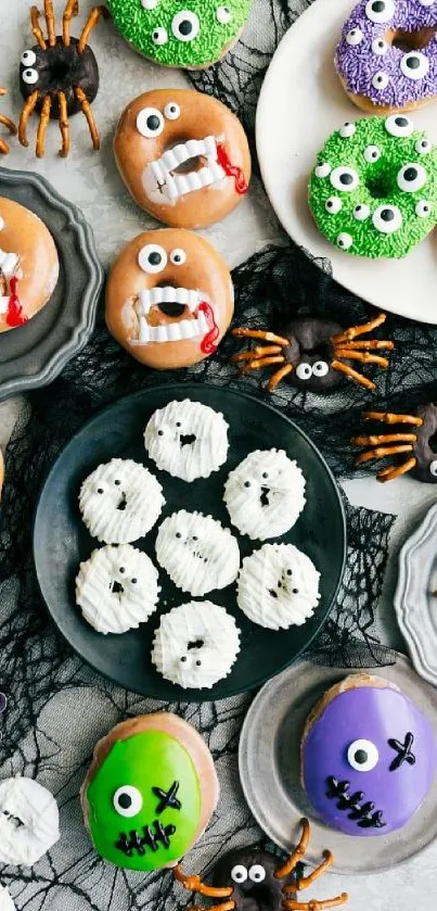 Spooky Halloween treats styled with monster donuts and spider cupcakes.