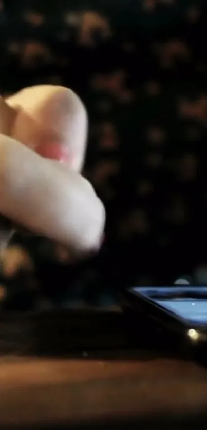 Closeup of a hand touching a smartphone screen on a dark background.