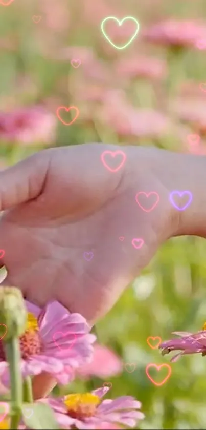 A hand touches pink flowers with glowing hearts in the background.