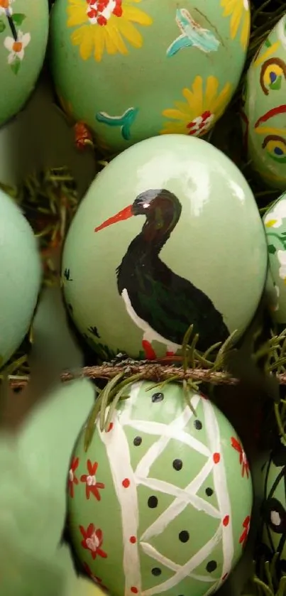 Closer look at artistically painted Easter eggs in light green hues.