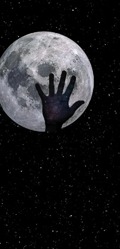 Hand reaching towards the moon on a starry black background wallpaper.