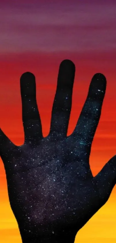 Silhouette of a hand against a vibrant sunset sky.